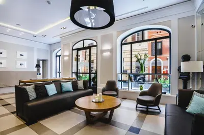 a living room with a couch and a table at Hotel Smeraldo in Rome
