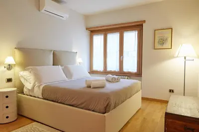 a bedroom with a large bed with two towels on it at Vatican Luxury Penthouse with Terrace in Rome