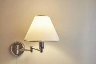 a lamp on a wall with a white lamp shade at Vatican Luxury Penthouse with Terrace in Rome