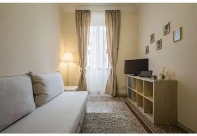 a living room with a couch and a television at EMI House Re di Roma, Intero Appartamento, 80 mq in Rome