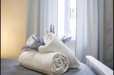 a white towel animal sitting on top of a bed at EMI House Re di Roma, Intero Appartamento, 80 mq in Rome