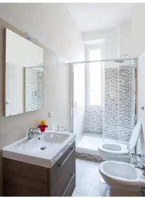 a bathroom with a sink and a toilet and a shower at EMI House Re di Roma, Intero Appartamento, 80 mq in Rome