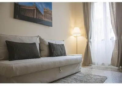 a living room with a couch and a lamp at EMI House Re di Roma, Intero Appartamento, 80 mq in Rome
