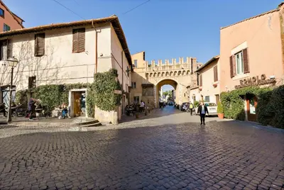 a person walking down a cobblestone street in an alley at Enchanting loft in Trastevere in Rome