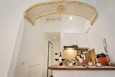 a kitchen with an archway over a kitchen counter at Enchanting loft in Trastevere in Rome