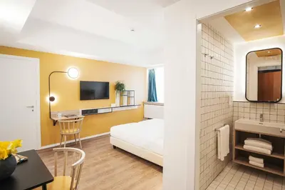 a hotel room with a bed and a bathroom at Aparthotel Colombo Roma in Rome