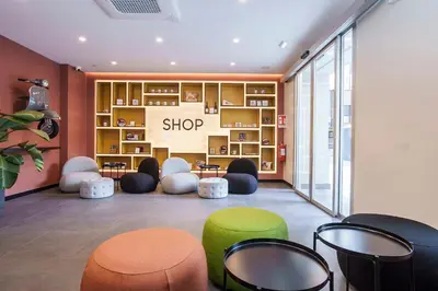 a shop with colorful chairs and tables in a room at Aparthotel Colombo Roma in Rome