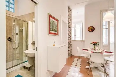 a bathroom with a table and a shower and a sink at La casa di Nonna Pina in Rome