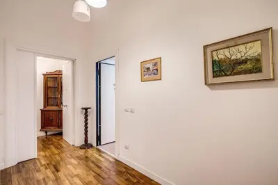 a room with a white wall and a picture on the wall at La casa di Nonna Pina in Rome