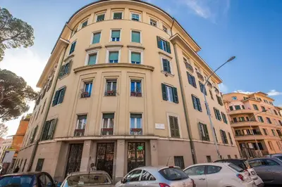 a tall building with cars parked in front of it at La casa di Nonna Pina in Rome