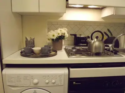 a kitchen counter with a stove and a tea kettle at Penna Apartment in Rome