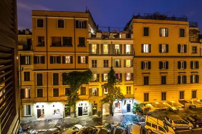a group of buildings with cars parked in a parking lot at Penna Apartment in Rome
