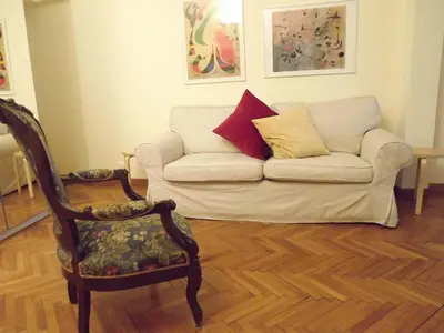 a living room with a couch and a chair at Penna Apartment in Rome