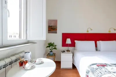 a bedroom with a red headboard and a white bed at Superior Relais FCollection Temple View in Rome