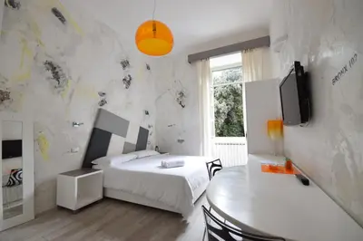 a bedroom with a bed and a table and a tv at Habana's Design in Rome