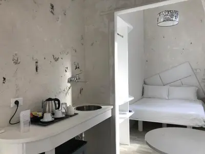 a kitchen with a sink and a bed in a room at Habana's Design in Rome