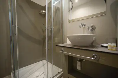 a bathroom with a shower and a sink at Romerooms in Rome