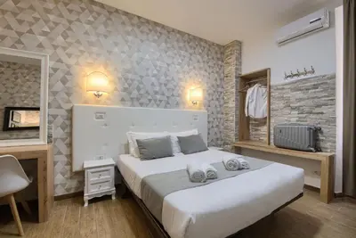 a bedroom with a large white bed in a room at Domus Pietro Inn in Rome
