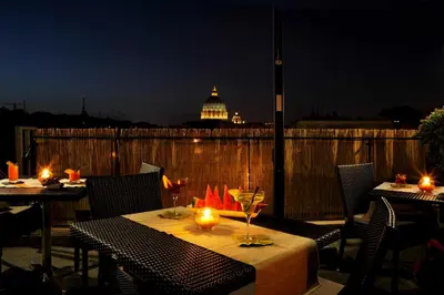 a table with candles on a patio with a building at Hotel Gravina San Pietro in Rome