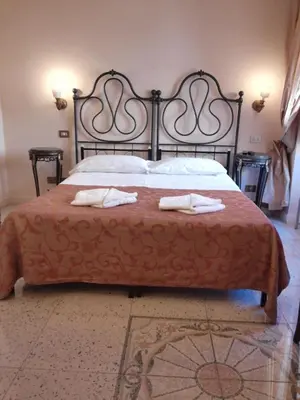 a bedroom with a bed with two towels on it at Maison de Marta in Rome