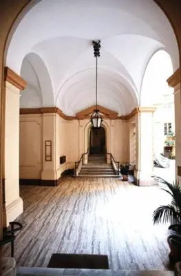 a large room with a hallway with a staircase at Maison de Marta in Rome