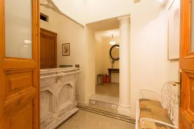 a living room with a fireplace and a mirror at Maison de Marta in Rome