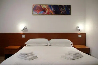 a bedroom with a bed with two towels on it at Principe Guesthouse in Rome