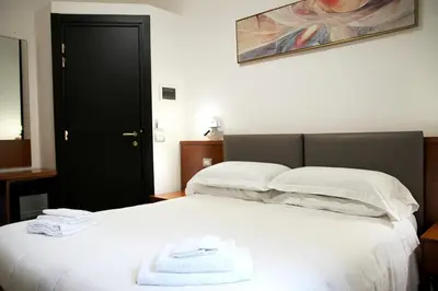 a hotel room with two beds with towels on the bed at Principe Guesthouse in Rome