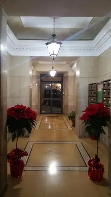 a hallway with red flowers in a building at Principe Guesthouse in Rome