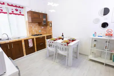 a kitchen with a white table and chairs in it at Baglioni Vatican House in Rome