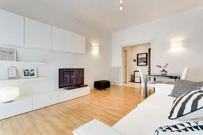 a living room with a white couch and a tv at Goldie in Rome