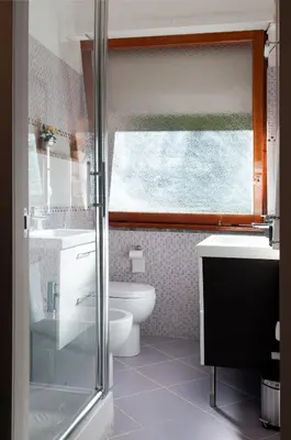 a bathroom with a toilet and a sink and a window at La Casetta del Vaticano in Rome