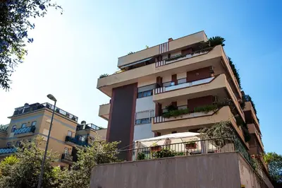 a tall building with balconies and plants on it at La Casetta del Vaticano in Rome