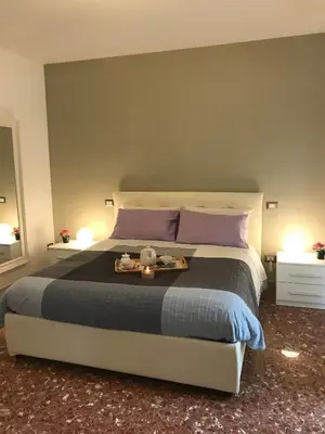 a bedroom with a large bed with a tray on it at Sweet Home Roma in Rome