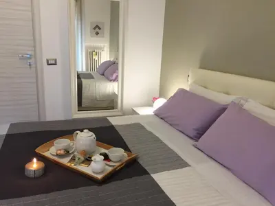 a bed with a tray with a tea set on it at Sweet Home Roma in Rome