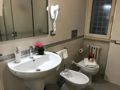 a bathroom with a sink and a toilet and a phone at Sweet Home Roma in Rome