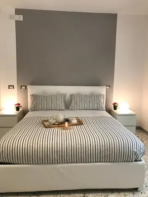 a bedroom with a white bed with a tray on it at Sweet Home Roma in Rome