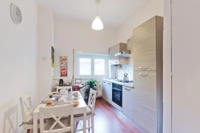 a kitchen with a table and chairs in a kitchen at Liberty Trastevere B&B in Rome