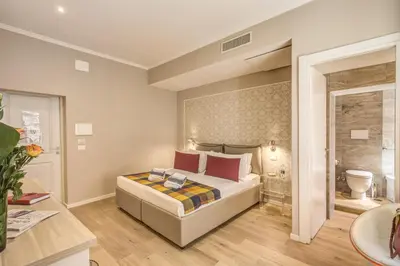 a bedroom with a bed and a bathroom at The Spanish Suite Via di Ripetta in Rome