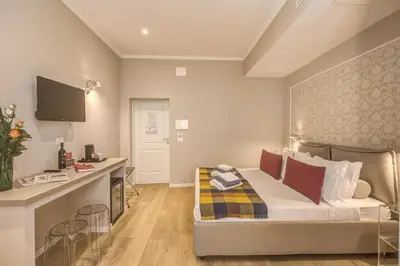 a hotel room with a bed and a desk at The Spanish Suite Via di Ripetta in Rome