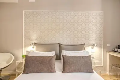 a bedroom with a bed with two pillows at The Spanish Suite Via di Ripetta in Rome