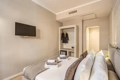 a living room with a couch and a flat screen tv at The Spanish Suite Via di Ripetta in Rome
