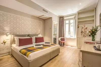 a bedroom with a large bed and a desk at The Spanish Suite Via di Ripetta in Rome