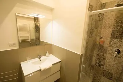 a bathroom with a sink and a shower at Stazione San Pietro 20 Apartment in Rome