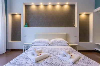a bedroom with a bed with two towels on it at Stazione San Pietro 20 Apartment in Rome