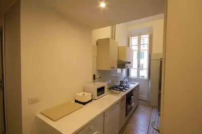 a kitchen with a white counter and a microwave at Stazione San Pietro 20 Apartment in Rome