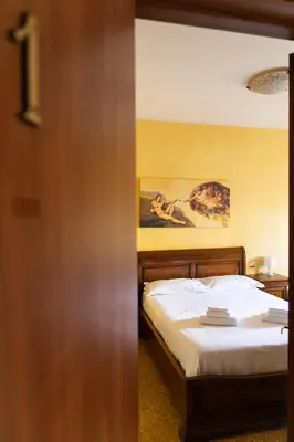 a bedroom with a bed and a painting on the wall at Cleopatra in Rome