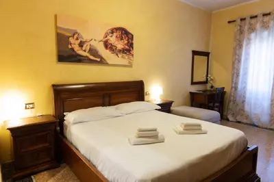 a bedroom with a bed with two towels on it at Cleopatra in Rome