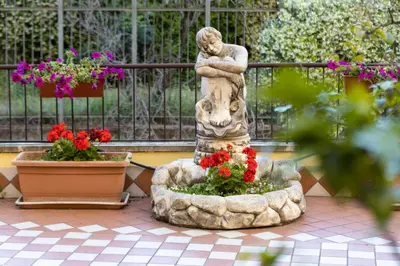 a statue of a woman standing next to flowers at Cleopatra in Rome