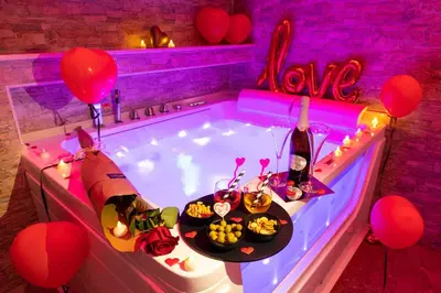 a jacuzzi tub with a table of food and balloons at Cleopatra in Rome